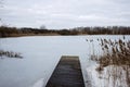 Wooden boat dock on a frozen winter lake. Royalty Free Stock Photo