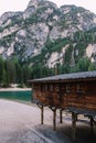 Wooden boat dock hut on the Lago di Braies on the background of rocky mountains and forests. Braies lake in the Royalty Free Stock Photo