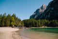 Wooden boat dock hut on the Lago di Braies on the background of rocky mountains and forests. Braies lake in the Royalty Free Stock Photo