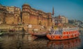 Colorful wooden boats docked along the shore of the Ganges River, at one of the many ghats in Varanasi, India. Royalty Free Stock Photo