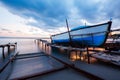 Wooden boat in a fishing village at sunset Royalty Free Stock Photo