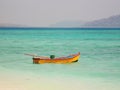 Wooden boat floating on sea at beach light blue beac at Havelock Island