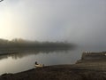 Wooden boat on a foggy autumn pond Royalty Free Stock Photo