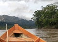Wooden boat front and green jungle landscape, sailing in the muddy water of the Beni river, Amazonian rainforest, Bolivia Royalty Free Stock Photo