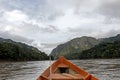 Wooden boat front and green jungle landscape, sailing in the muddy water of the Beni river, Amazonian rainforest, Bolivia Royalty Free Stock Photo