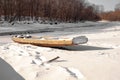 Wooden boat on a frozen river in a Russian village Royalty Free Stock Photo