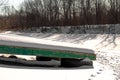 Wooden boat on a frozen river in a Russian village Royalty Free Stock Photo