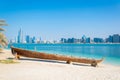 Wooden boat at the Heritage Village, in front of the Abu Dhabi skyline, United Arab Emirates...IMAGE Royalty Free Stock Photo