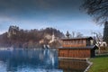 Wooden boat house on the lake Bled with the castle and church of St. Martin Royalty Free Stock Photo