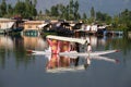 Wooden boat and indian people in lake. Srinagar, India Royalty Free Stock Photo