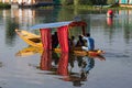 Wooden boat and indian people in lake. Srinagar, India Royalty Free Stock Photo