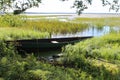 Russia, Pleshcheyevo lake: Wooden boat on the overgrown shore Royalty Free Stock Photo