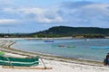 Wooden boat laying by the Tanjung Aan Shore during a vibrant sunrise. Taken in Central Lombok. Lombok, Indonesia, March 22, 2022