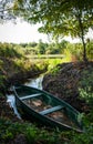 Wooden boat moored in the bay of the river among the reeds Royalty Free Stock Photo