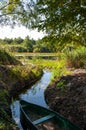 Wooden boat moored in the bay of the river among the reeds Royalty Free Stock Photo