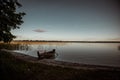 Wooden boat is moored near the lake