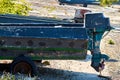 A wooden boat with a motor is parked on land. The old boat is on the rocks. Wooden motor boat. The old boat is on the shore Royalty Free Stock Photo