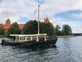 Wooden boat that offer sightseeing tours in the lake surrounding the Trakai Island Castle in Trakai, Lithuania. Royalty Free Stock Photo
