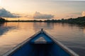 Wooden boat overlooking the sunset or sunrise in the Amazon river Royalty Free Stock Photo