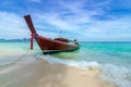 Wooden boat parked on the sea, white beach on a clear blue sky, blue sea Royalty Free Stock Photo