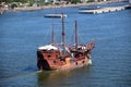 Wooden boat passing near cargo passenger terminal Royalty Free Stock Photo