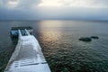 Wooden boat pier covered with ice and snow with icicles Royalty Free Stock Photo