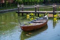 Wooden boat on the pond near the pier in a tropical garden in Danang, Vietnam Royalty Free Stock Photo