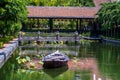 Wooden boat on the pond near the pier in a tropical garden in Danang, Vietnam Royalty Free Stock Photo