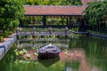 Wooden boat on the pond near the pier in a tropical garden in Danang, Vietnam Royalty Free Stock Photo