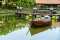 Wooden boat on the pond near the pier in a tropical garden in Danang, Vietnam Royalty Free Stock Photo