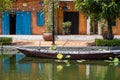 Wooden boat on the pond near the pier in a tropical garden in Danang, Vietnam Royalty Free Stock Photo