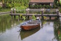 Wooden boat on the pond near the pier in a tropical garden in Danang, Vietnam Royalty Free Stock Photo