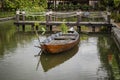 Wooden boat on the pond near the pier in a tropical garden in Danang, Vietnam Royalty Free Stock Photo