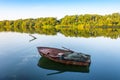 A wooden boat in the riverÃÂ© fishing boat in a calm lake water/old wooden fishing boat/ wooden fishing boat in a still lake water Royalty Free Stock Photo