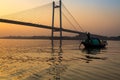 Wooden boat on river Hooghly at twilight near Vidyasagar bridge setu, Kolkata, India. Royalty Free Stock Photo