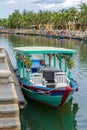 Wooden boat on the river water in old city of Hoi An, Vietnam Royalty Free Stock Photo