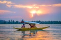 A wooden boat shikara in Dal Lake, Srinagar, Kashmir on a beautiful sunset evening
