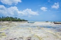 Wooden boat on tropical beach. Low tide landscape with fishing boats. Sailboats on low tide of Indian ocean. Zanzibar seacoast. Royalty Free Stock Photo