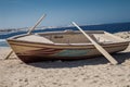 Wooden boat with two oars on beach Royalty Free Stock Photo