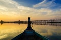 Wooden boat in Ubein Bridge at sunrise, Mandalay, Myanmar Royalty Free Stock Photo