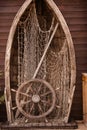 Wooden boat wall composition with fishing net andvitage ship`s wheel helm. Art desing