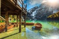 Wooden boathouse and boats on the alpine lake, Dolomites, Italy Royalty Free Stock Photo
