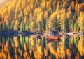 Wooden boats on Braies lake at sunrise in autumn Royalty Free Stock Photo