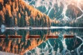 Wooden boats on Braies lake at sunrise in autumn