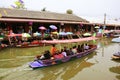 Wooden boats busy ferrying people at Amphawa floating market