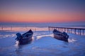 wooden boats on frozen lake in winter Royalty Free Stock Photo