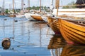 Rowboats and sailboats lined up in a row on a summer day. Royalty Free Stock Photo