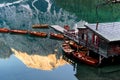 Wooden boats and house on Lake Braies, Dolomites, Italy. Reflection of mountains Royalty Free Stock Photo