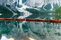 Wooden boats in the Lake Braies, Dolomites, Italy. Reflection of mountains Royalty Free Stock Photo