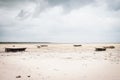 Wooden boats on low tide, toned. Zanzibar beach with old nautical vessel. African seascape with cloudy sky. Empty coast of ocean. Royalty Free Stock Photo